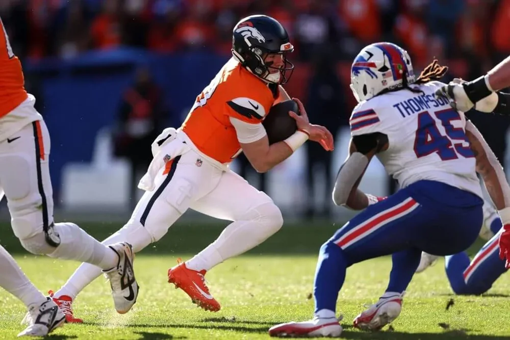 Bo Nix of the Denver Broncos runs for a first down against the Buffalo Bills.